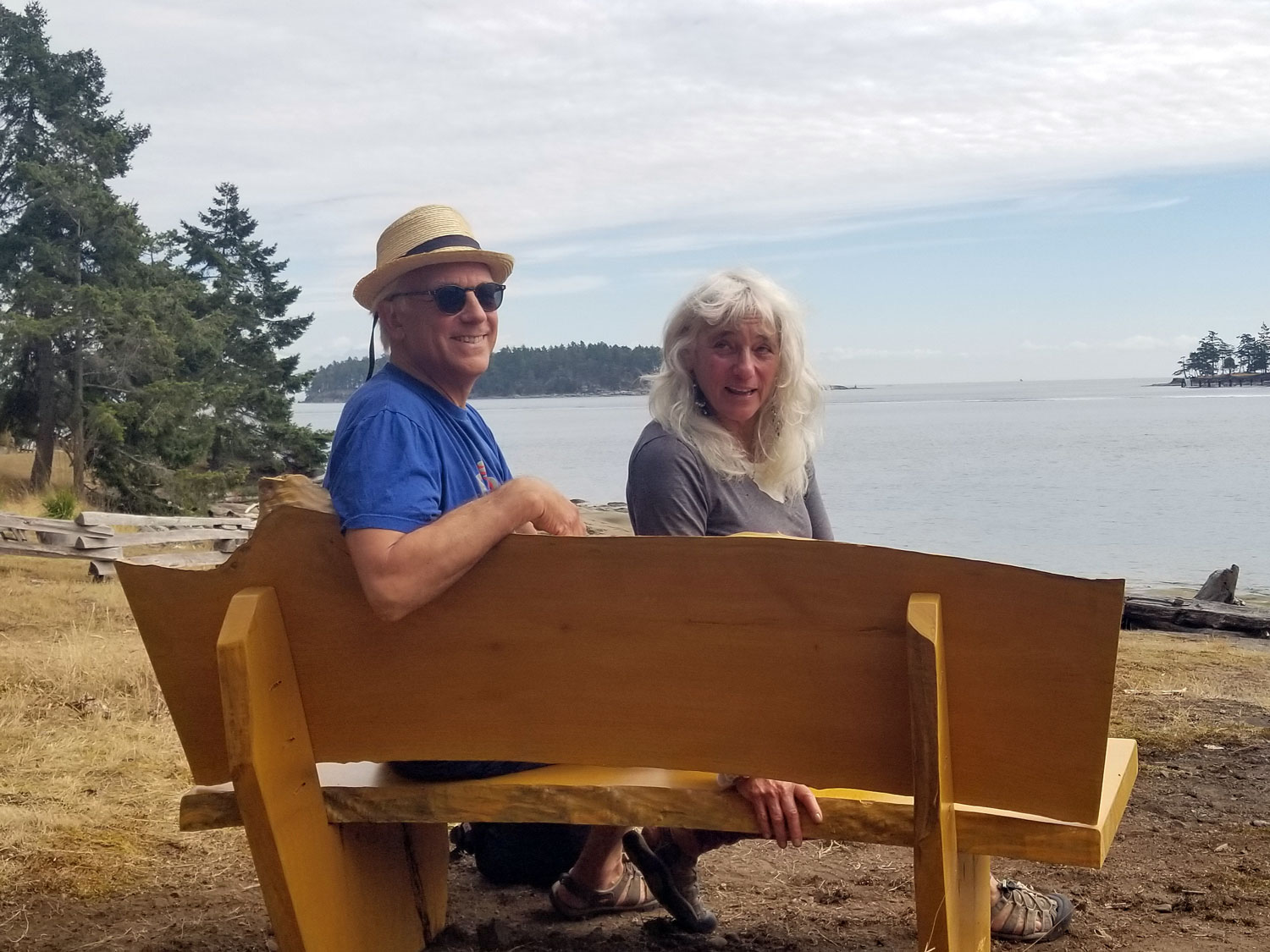 two people sitting on a wooden bench