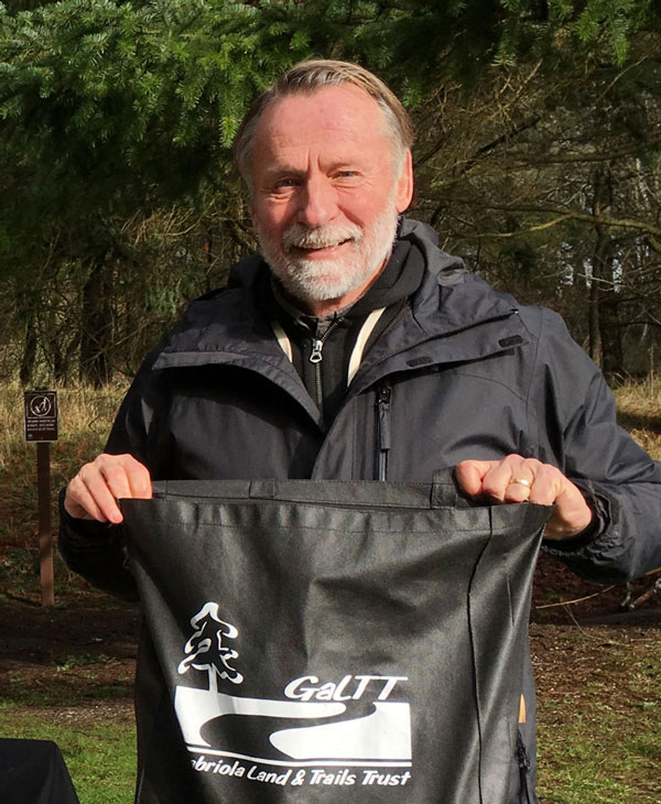 Photo of a man holding a GaLTT tote bag.