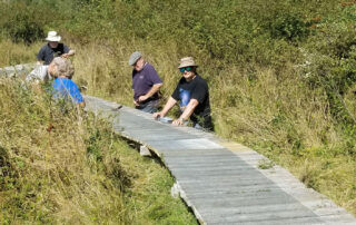 Group of people working on boardwalk repairs at Gabriola Commons