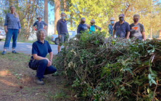 Group of volunteers with large daphne pile.