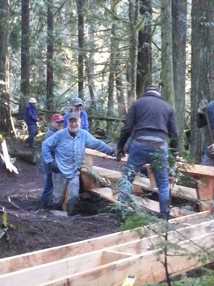 Group of people building a boardwalk.