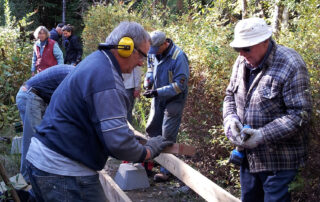 Group of people working on building a boardwalk.