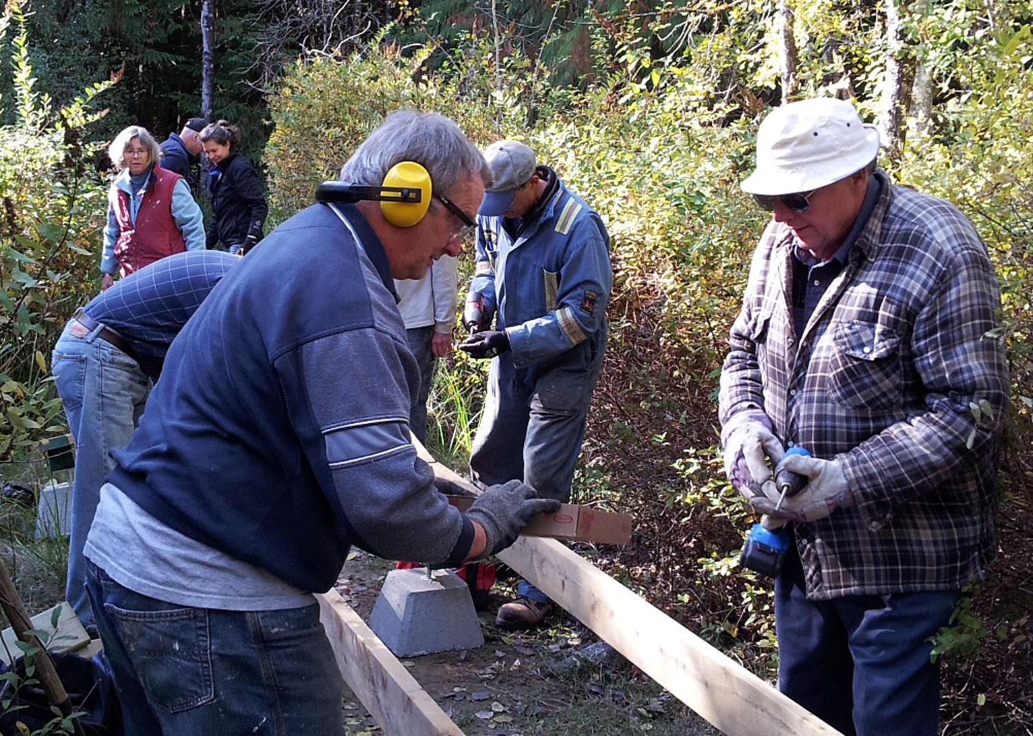 Group of people working on building a boardwalk.